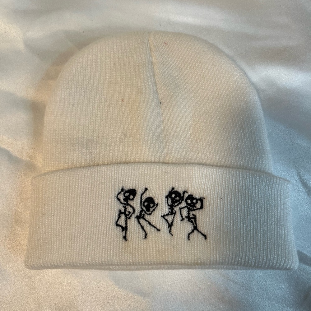 White beanie with black skeletons.